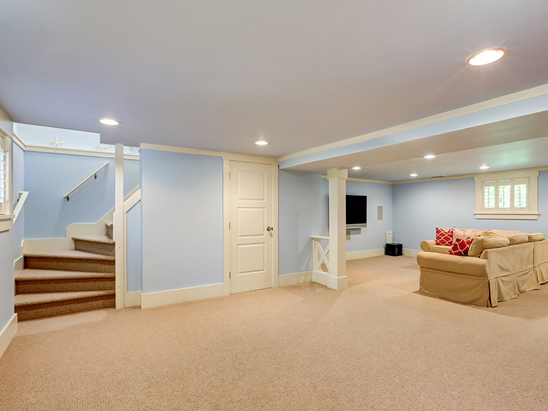 finished basement with light blue walls and tan couch lakeville mn